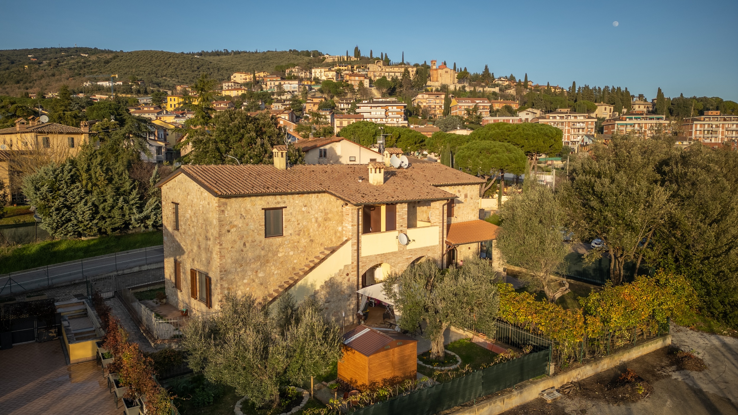 Aerial view of Casale Corciano with the village of Corciano on the hill behind